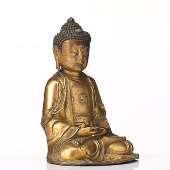 A gilt bronze figure of Amithaba Buddha, Ming dynasty (1368-1644).