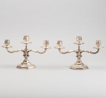 A pair of silver candelabras.