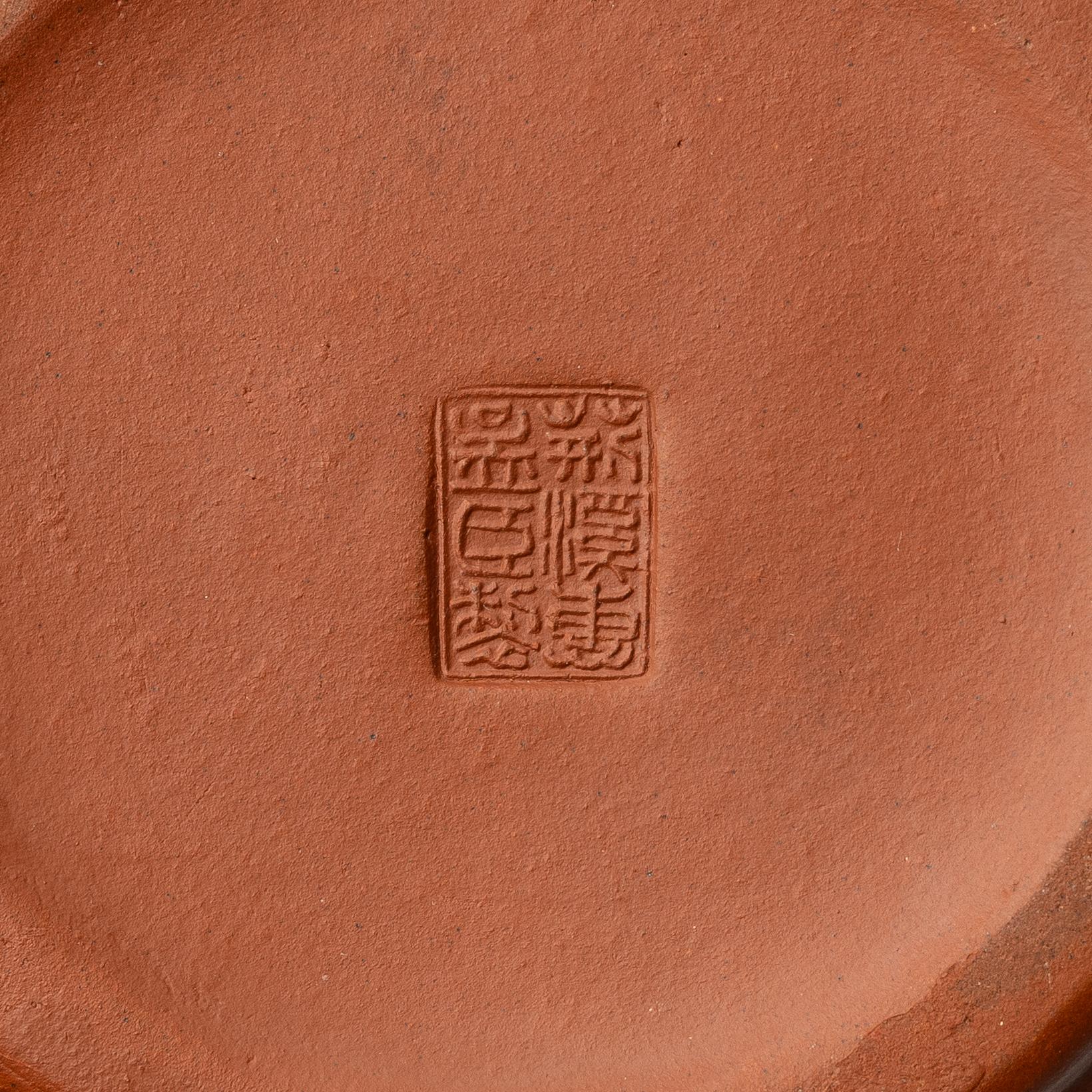 A six part red yixing Gongfu set; teapot, four cups and a tray, China, 1980s.