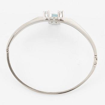 A bangle 18K white gold with aquamarine and two round brilliant-cut diamonds.
