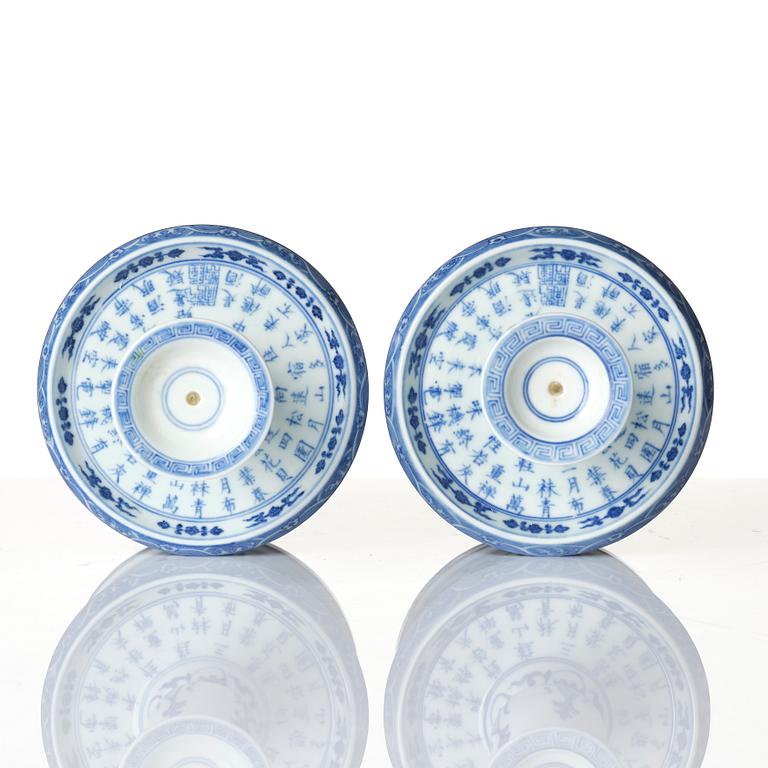 A pair of blue and white pricket candle sticks, with a poem, Qing dynasty with a Qianlong mark and of the period.