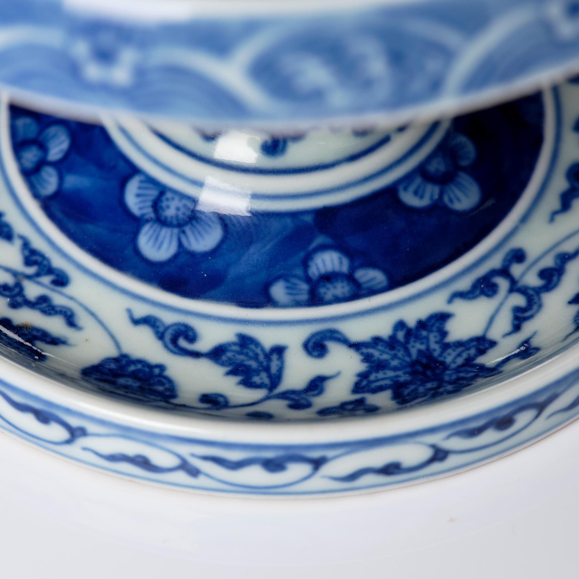 A pair of blue and white pricket candle sticks, with a poem, Qing dynasty with a Qianlong mark and of the period.