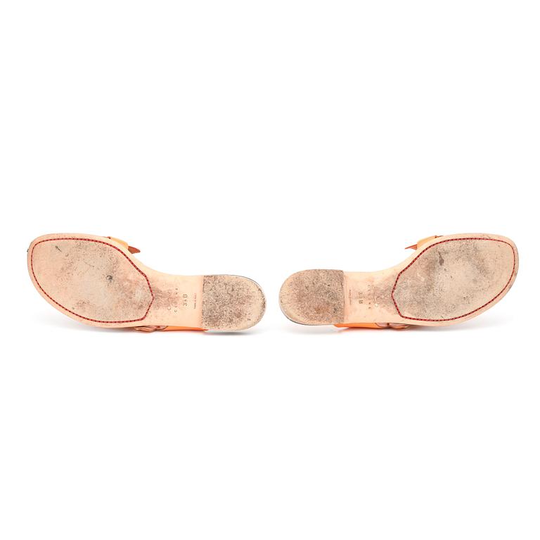 CÉLINE, a pair of orange leather sandals.