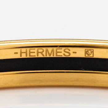 Hermès, a bracelet made of gold coloured metal and green enamel. Marked Hermès Paris, Made in France.