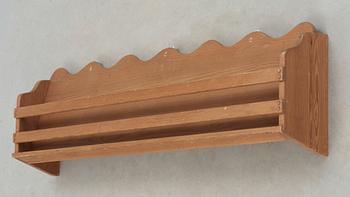 A stained pine wall-shelf attributted to Axel-Einar Hjorth, probably 'Utö', Nordiska Kompaniet, Sweden.