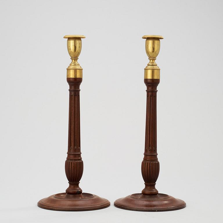 A pair of George III 18th century mahogany candlesticks.