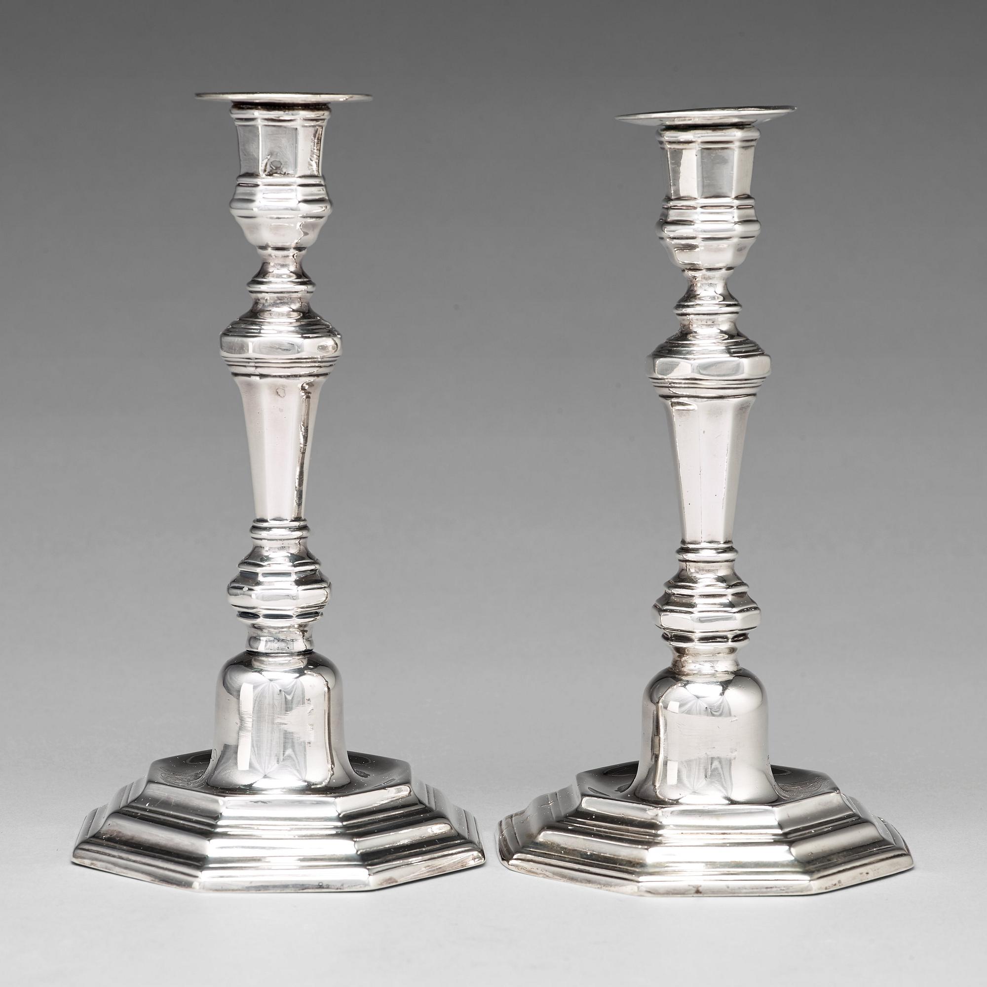 A pair of European 18th century silver candlesticks, unidentified makers mark.