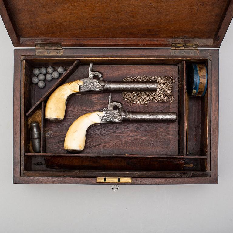 A mid 19th century Belgian rifled percussion pistols with ivory butts in a case.