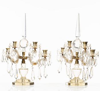 A pair of brass and glass canelabras, first half of the 20th century.