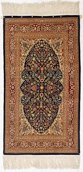 A Hereke silk rug, c. 130 x 71 cm.