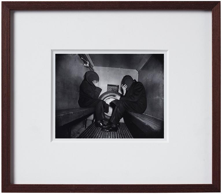 Weegee, "Charles Sodokoff and Arthur Webber using their top hats to hider their faces, New York, January 26 1942".