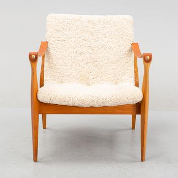 Ebbe & Karen Clemmensen, an armchair/safari chair model 4305, with sheepskin, Fritz Hansen, model designed in 1958.