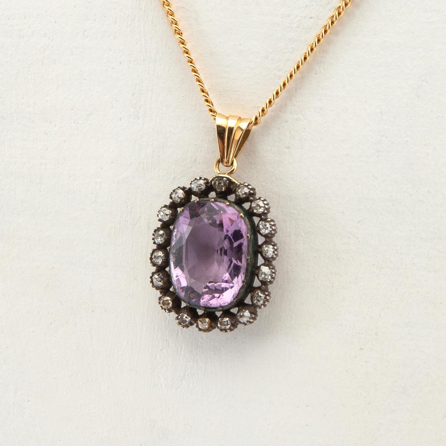 Pendant, 18k gold with diamonds and purple stone.