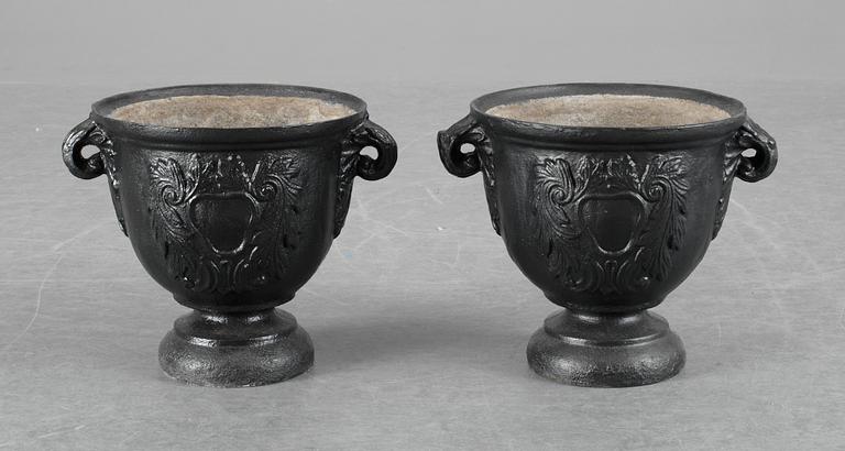 A pair of Baroque-style iron garden urns.