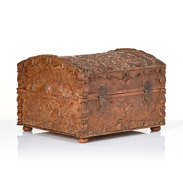 A baroque wedding casket, carved wood, dated 1725.