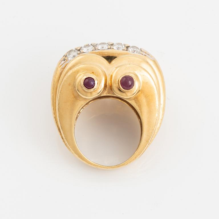 An 18K gold ring set with round brilliant-cut diamonds and cabochon-cut rubies.