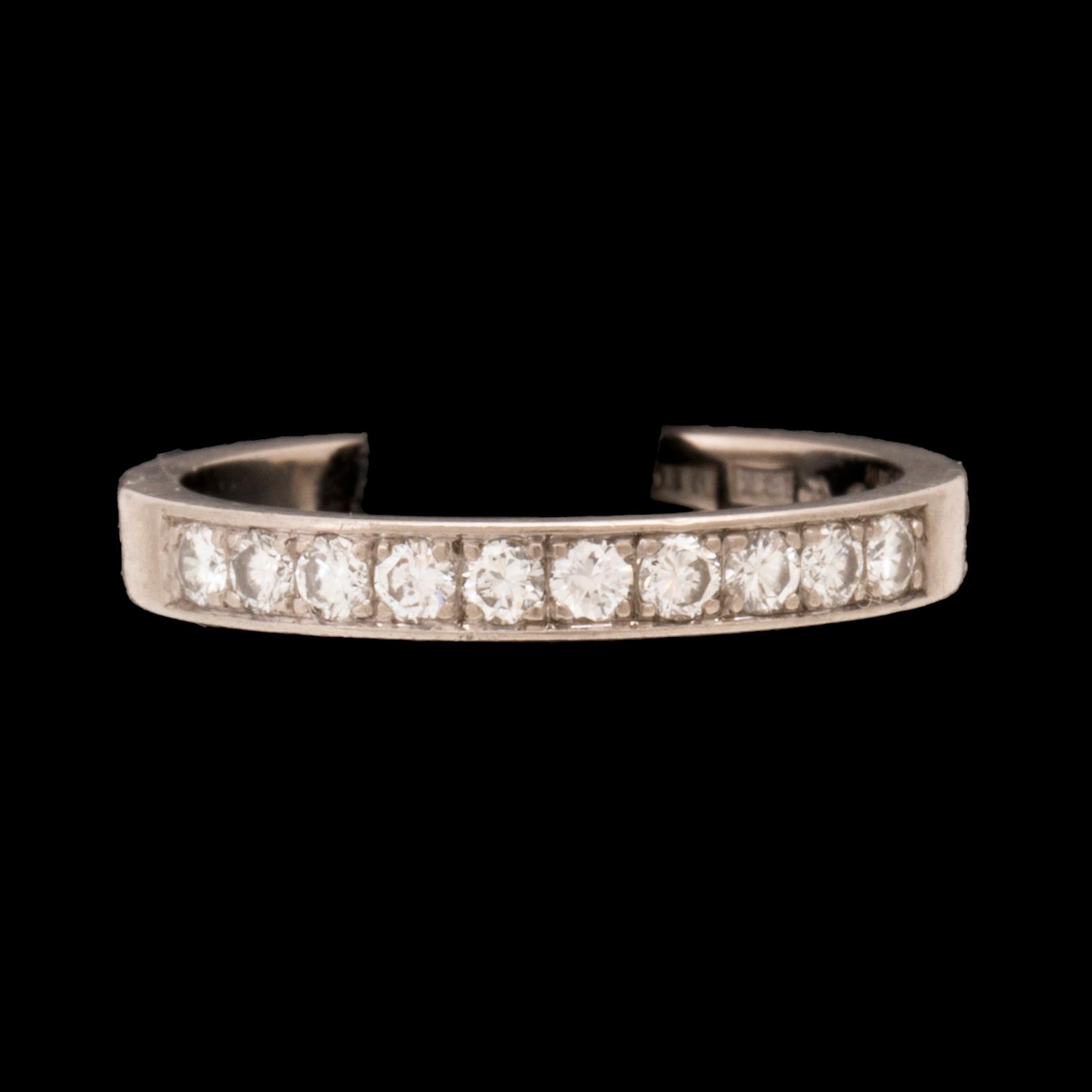 An 18K white gold half eternity ring set with round brilliant-cut diamonds.