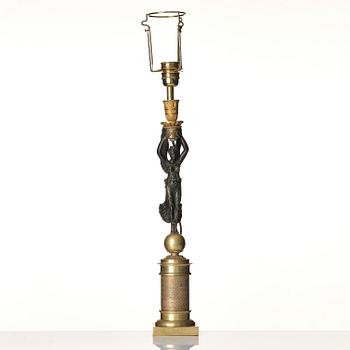 A French Empire ormolu and patinated bronze table lamp, early 19th century.