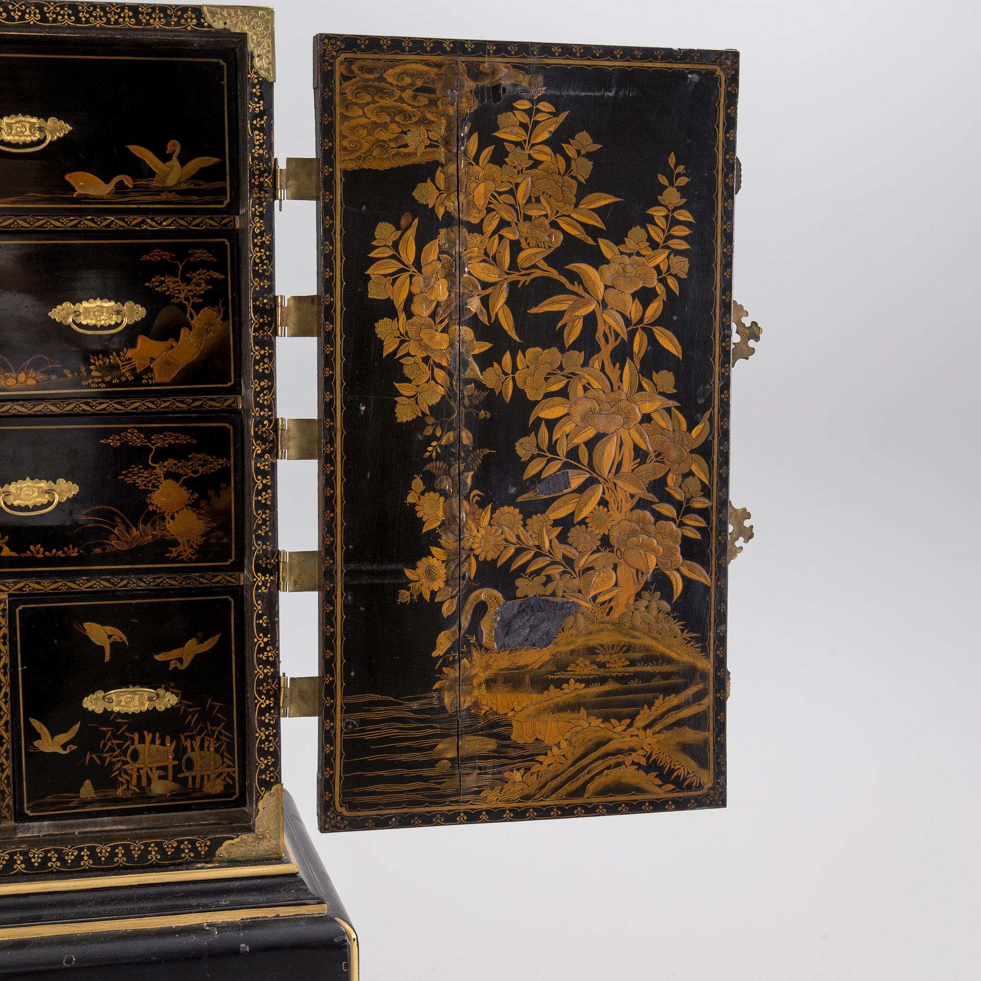 AN early 18TH CENTURY PROBABLY ENGLISH Japanned laquer cabinet on stand.