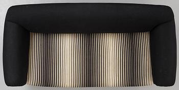 A 1940's sofa, upholstered in black and white striped fabric.