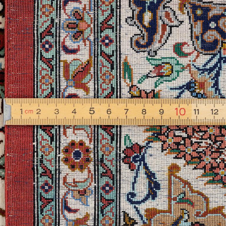 A Ghom silk rug, signed, c. 148 x 100 cm.