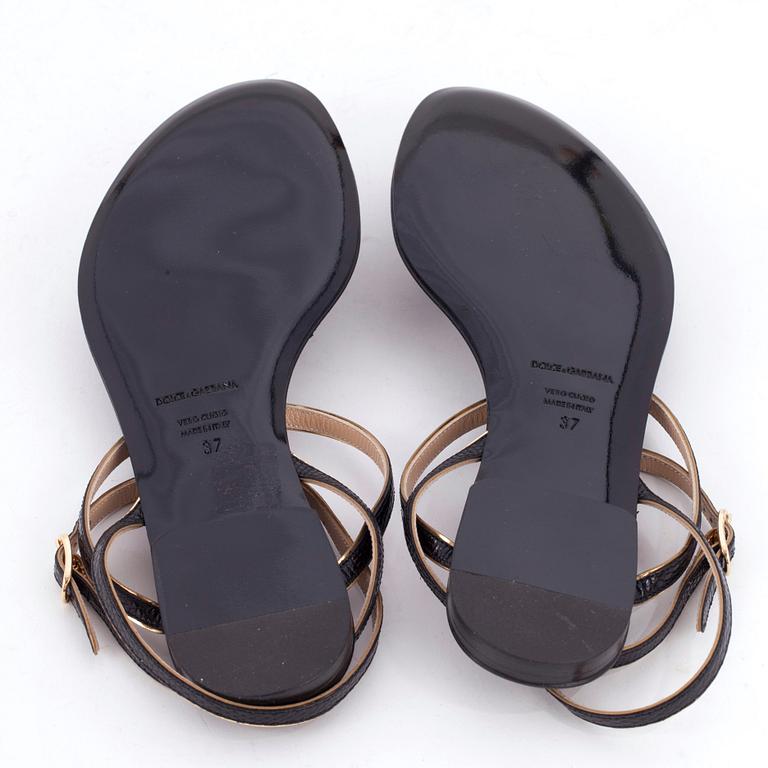 DOLCE & GABBANA, a pair of black leather sandals.