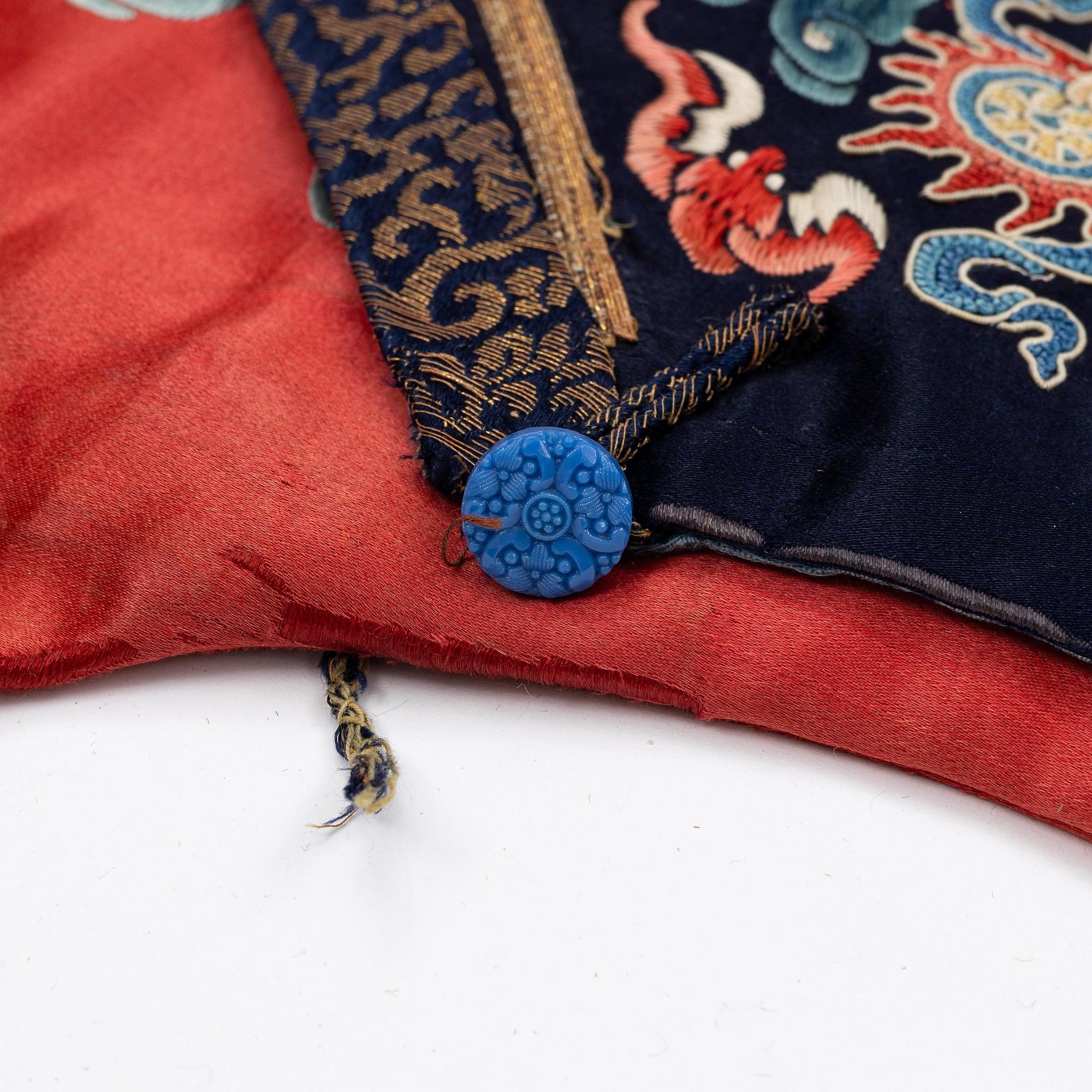 An embroidered red ground five clawed dragon 'female' formal robe, Qing dynasty, 19th century.