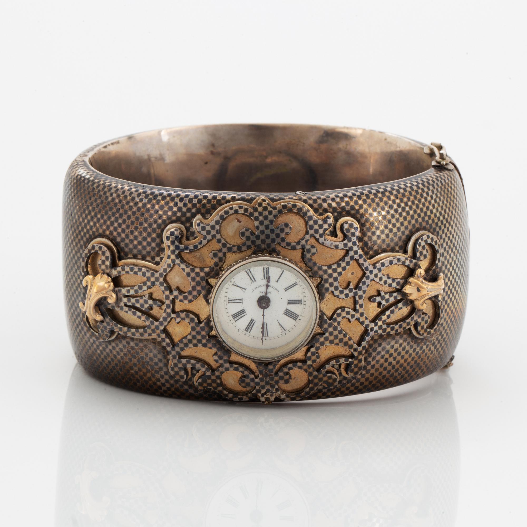 Silver bangle with watch.