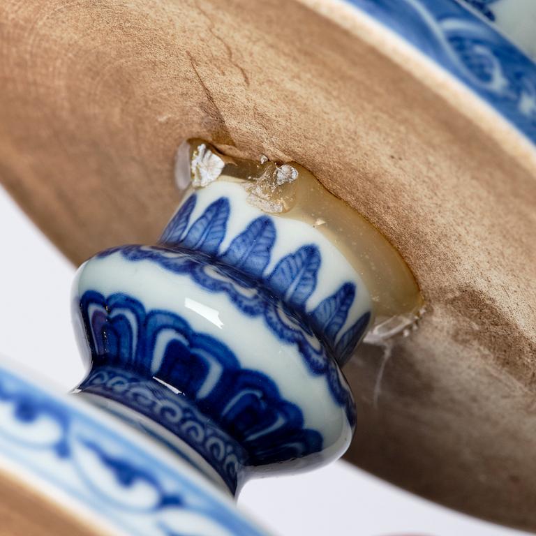 A pair of blue and white pricket candle sticks, with a poem, Qing dynasty with a Qianlong mark and of the period.