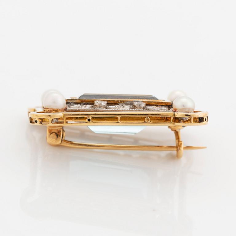 An 18K gold and enamel brooch set with a faceted aquamarine, pearls and old-cut diamonds.