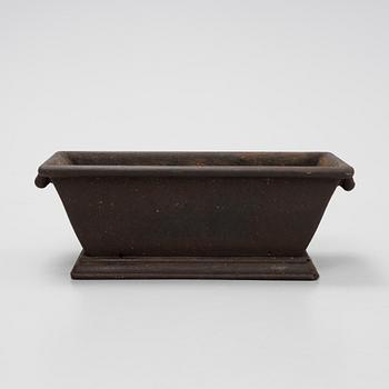 A cast iron plant pot, 20th Century.