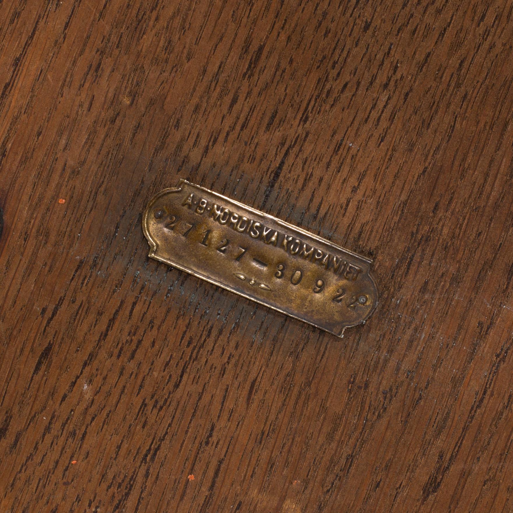 AN OAK TABLE FROM NORDISKA KOMPANIET, 1921.