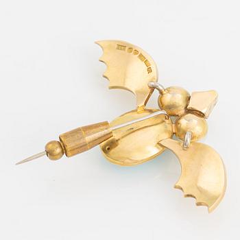 An 18K gold brooch set with a turquoise and cultured pearls.