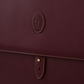 Wine-colored leather briefcase by Cartier.