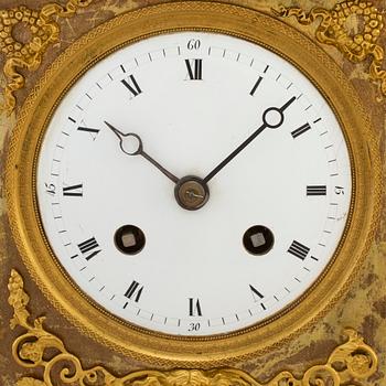 A French Empire gilt bronze mantel clock, first half of the 19th century.