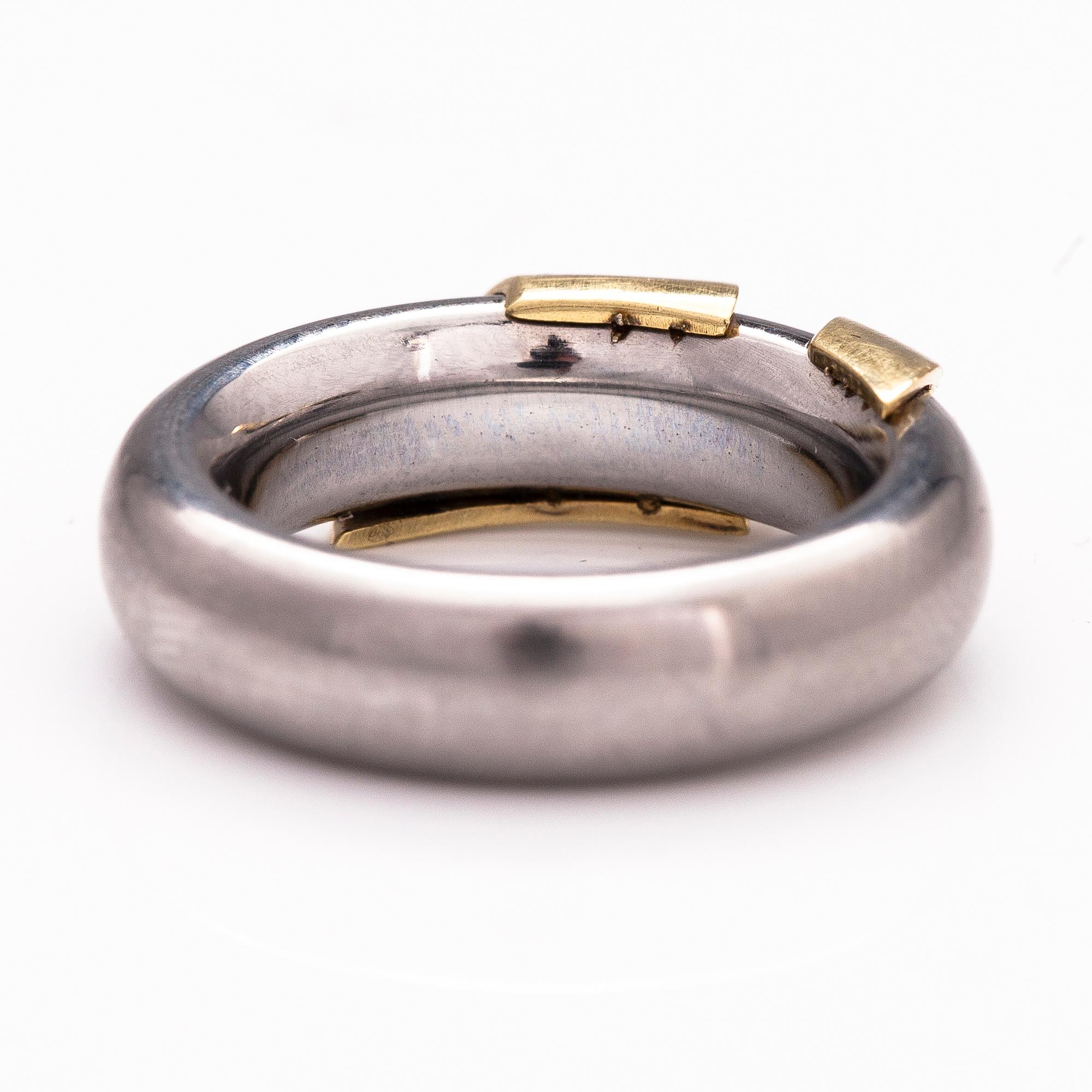 A steel and gold ring with a diamond ca. 0.015 ct.