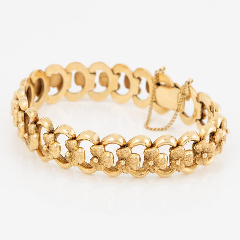 Arm bracelet, 18K gold, decoration of flowers.