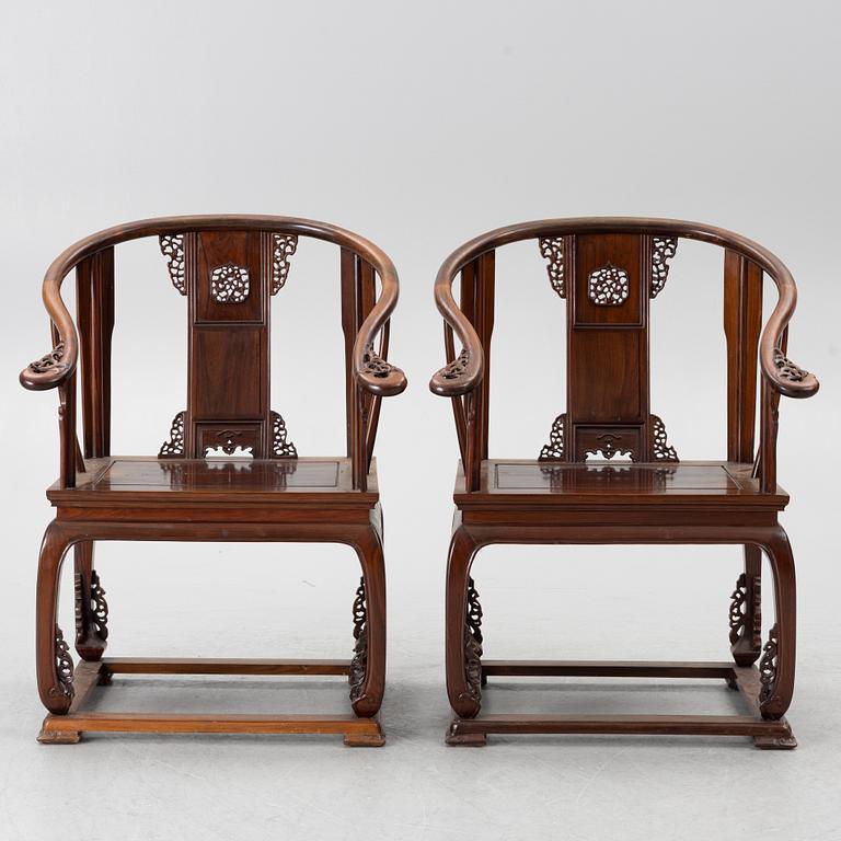 A pair of Chinese horseshoe-back hardwood armchairs, 1900s.