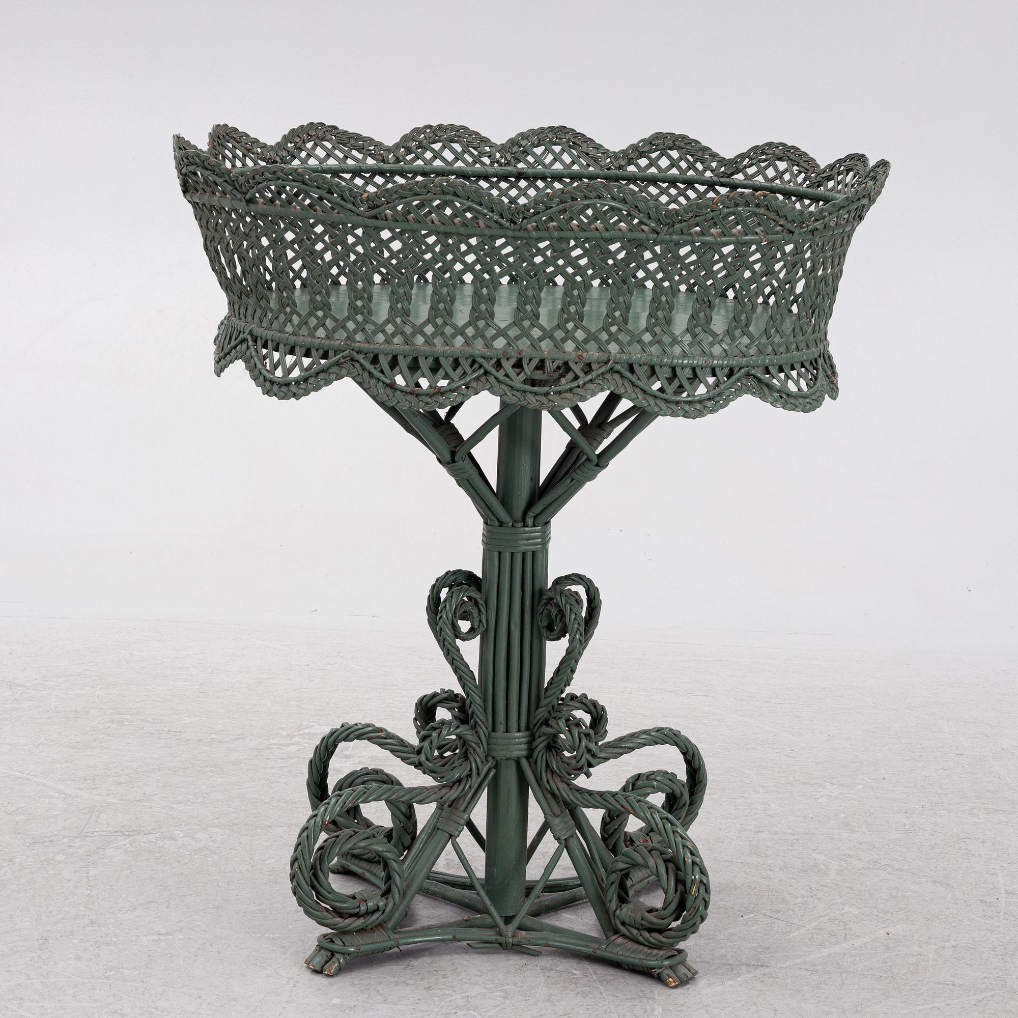 A wicker flower table, early 20th century.