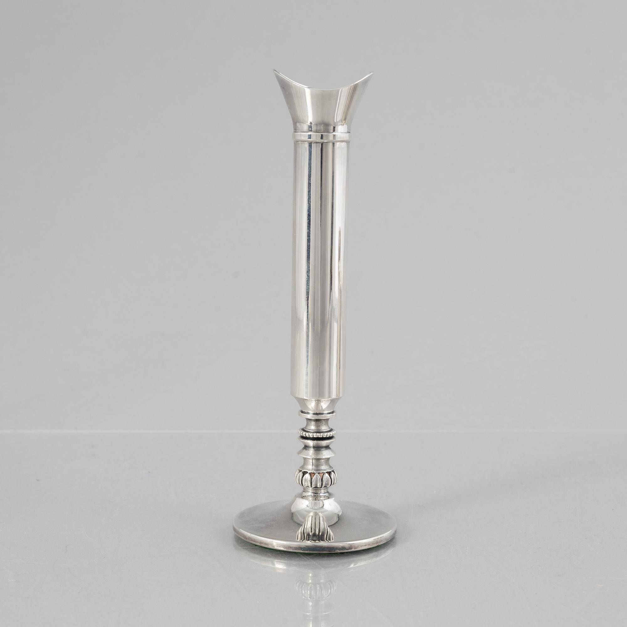 Eric Löfman, a Swedish silver candlestick, a vase and four cups, including MGAB, Uppsala 1977.