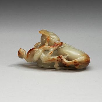 A carved nephrite figure of a parrot among peaches, Qing dynasty.