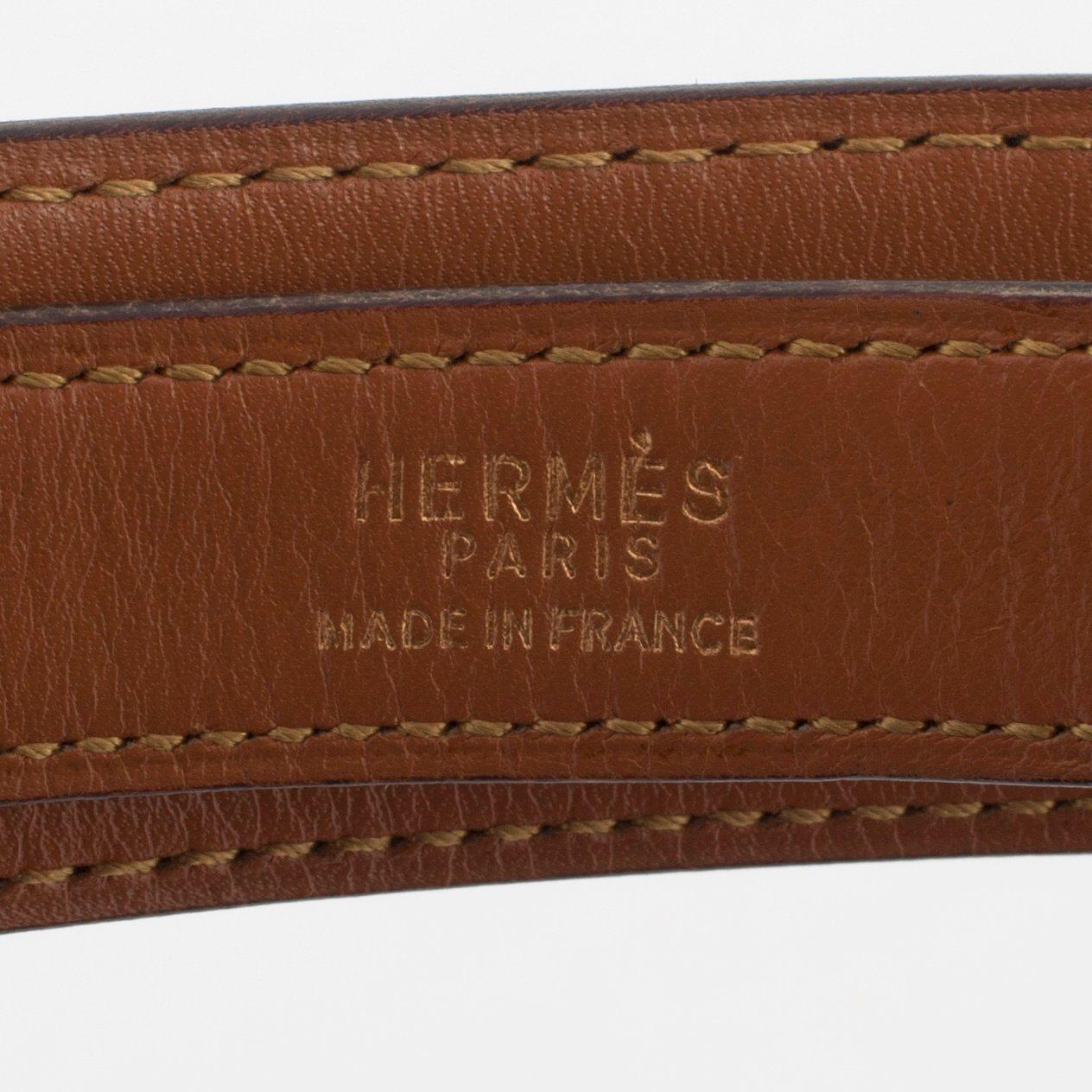 HERMÈS, a black leather belt.