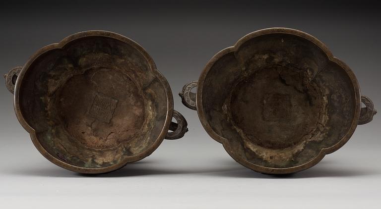 A pair of lobed bronze flower pots, Qing dynasty, with Xuandes six character mark to the interior.