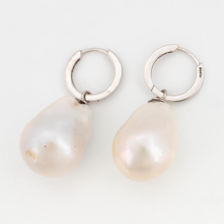 Cultured baroque pearl and diamond earrings.