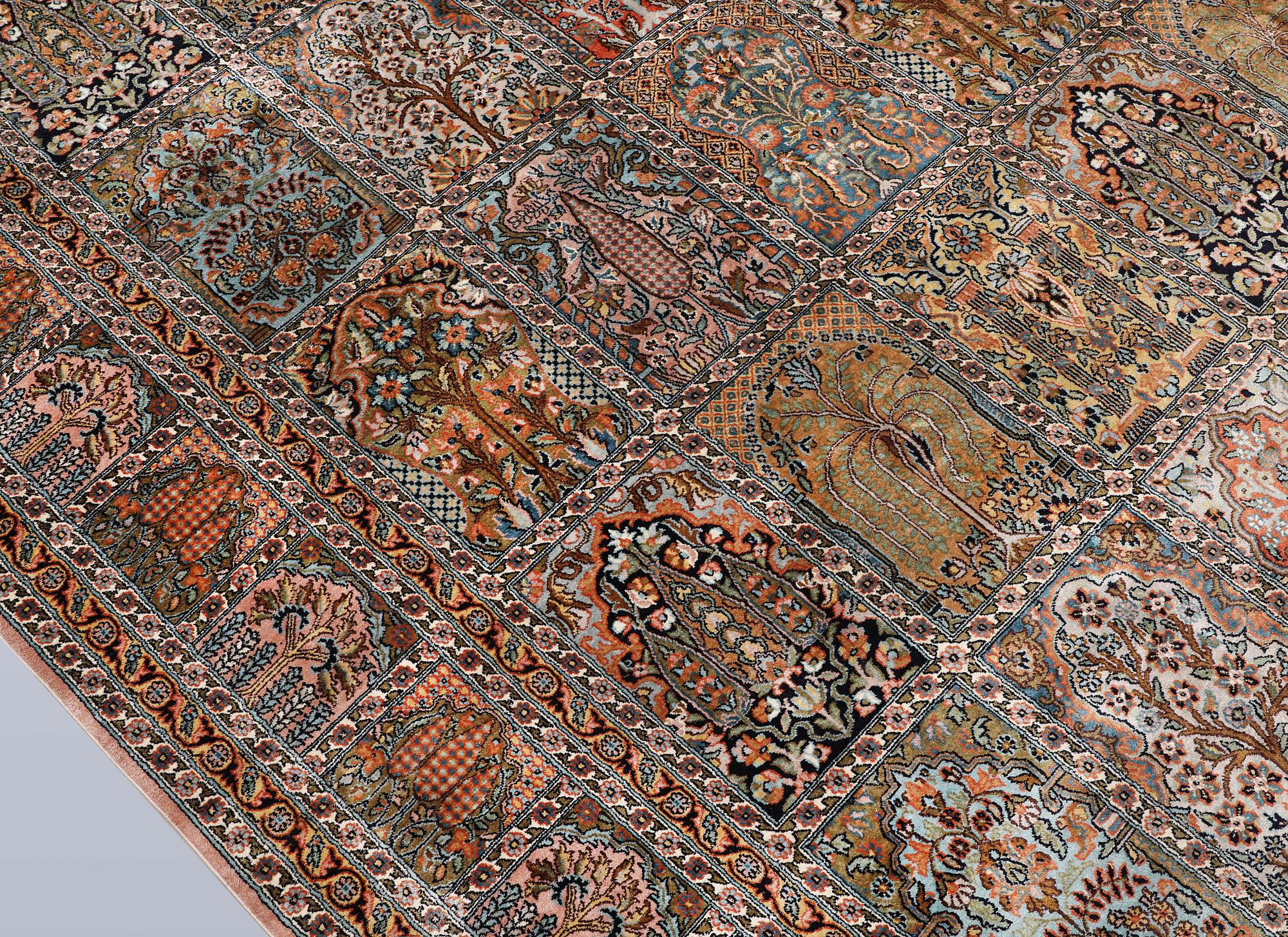 A Kashmir silk carpet, 418 x 297 cm.
