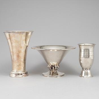 Two silver beakers and a bowl.