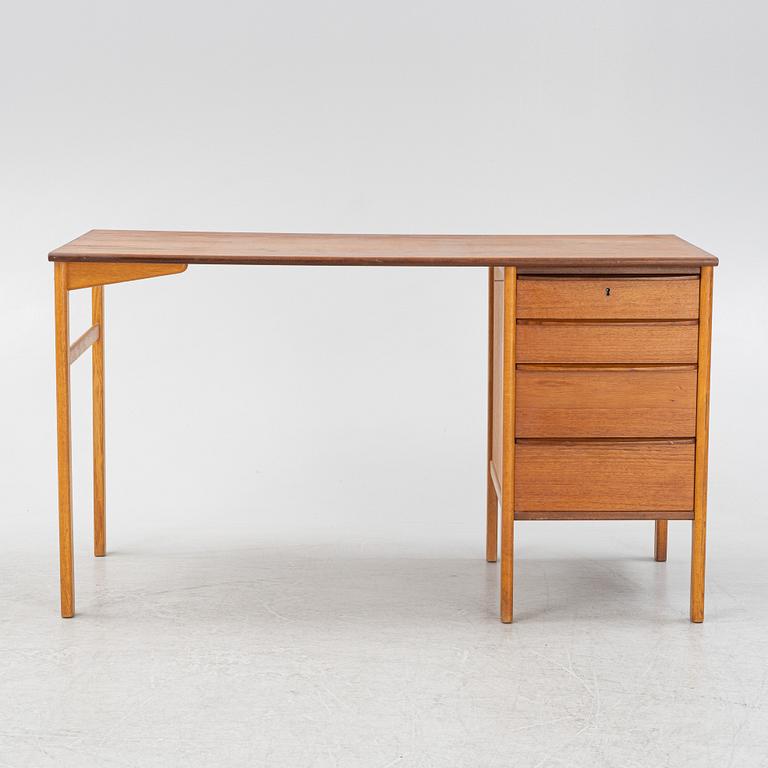 A teak veneered writing desk, 1960s.