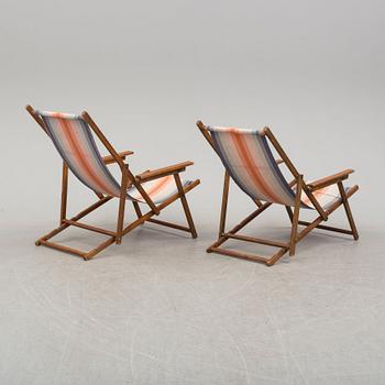 A pair of  mid 20th century beach chairs.