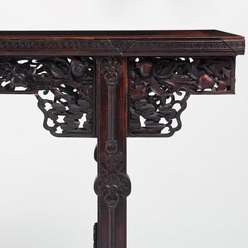 A massive zitan recessed-leg long table 'Jiaotousun Qiotouan', Qing dynasty, 19th century.