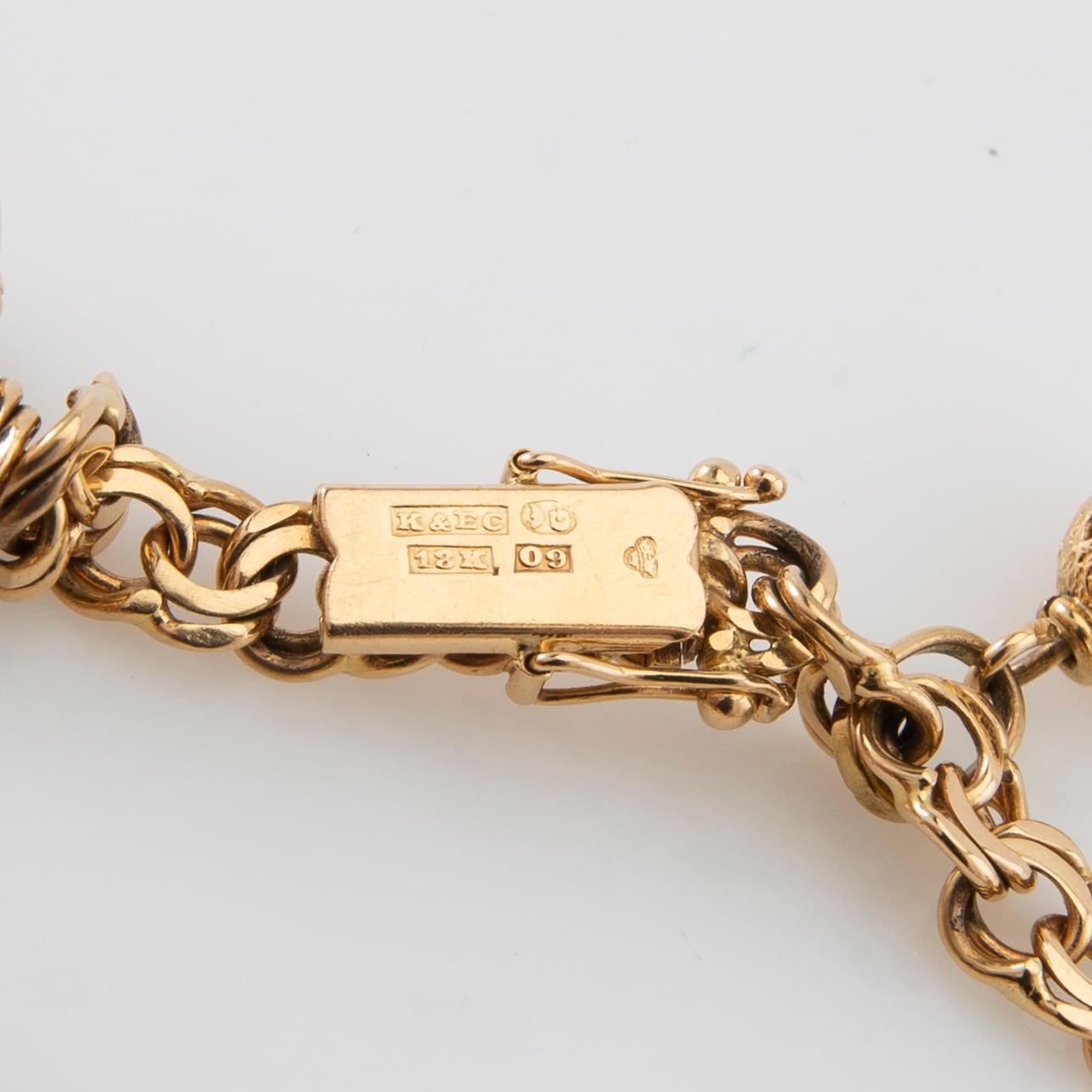 Armband Bismarck-länk 18K guld med berlocker.